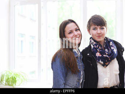 Two female students near the window in classroom Stock Photo