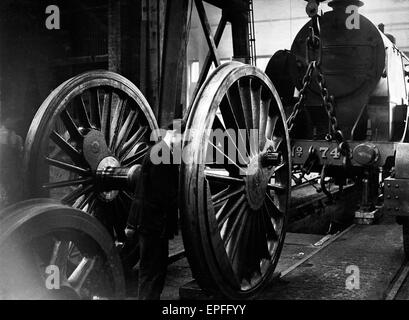 Locomotive wheels seen here under going maintenance at the Southern Railways engine shed at  Nine Elms July 1932 Stock Photo