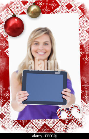 Composite image of tablet computer being held by a blonde woman Stock Photo