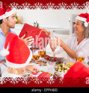 Composite image of family exchanging christmas presents Stock Photo