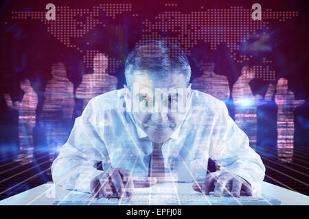 Composite image of mature businessman typing on keyboard Stock Photo