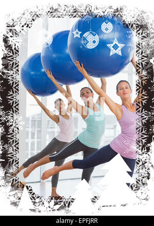 Composite image of fitness class doing pilates exercise with fitness balls Stock Photo