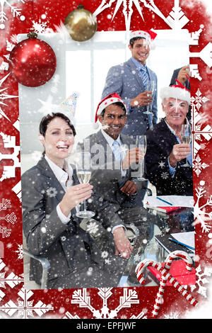 Manager and his team with novelty christmas hat toasting at a party Stock Photo