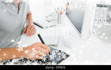 Composite image of casual male photo editor using graphics tablet Stock Photo