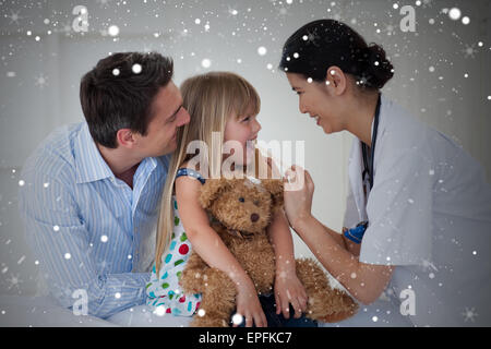 Composite image of female doctor checking her patients throat Stock Photo