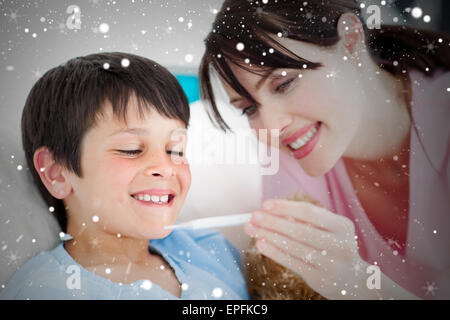 Composite image of positive nurse and his patient looking at a thermometer Stock Photo