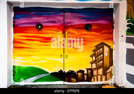 Mural painted on garage doors depicting the hanging houses. Stock Photo