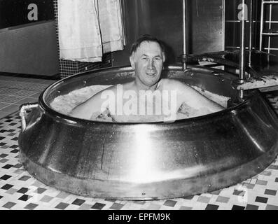 Joe Mercer the Manchester City manager seen here soaking in a tub at Blackpool sauna bath. 6th February 1969 Stock Photo