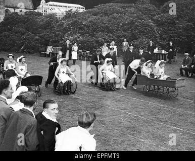 Sports Day for Patients and Staff from Maristow Royal Naval Auxiliary Hospital near Yelverton, Devon, September 1944.  Invalid Chair Race held on the lawn of the home of the Earl of Roborough. The nurses decided to join in the fun & changed places, while Stock Photo