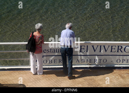 Elderly couple looking at sea view from restaurant terrace in Sitges, Costa Dorada, Catalonia, Spain Stock Photo