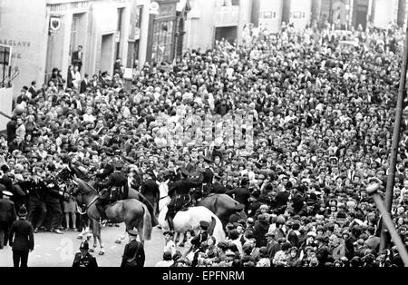 The Beatles in Liverpool for the Premier of a Hard Day's Night. Police use horses to try and control the crowds gathering at the premier. 10th July 1964.