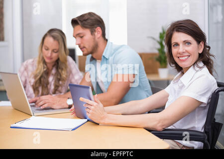 Business people using digital tablet and laptop in meeting Stock Photo