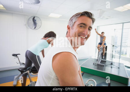 Spin class working out with motivational instructor Stock Photo