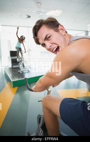 Handsome man smiling at camera in spin class Stock Photo