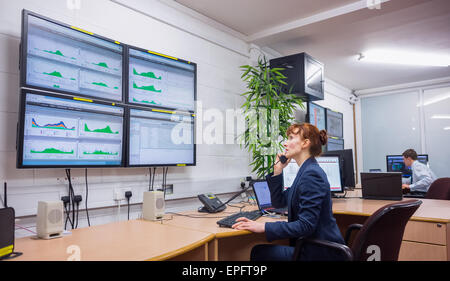 Technician sitting in office running diagnostics Stock Photo