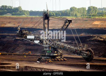 Mining with a giant bucket wheel excavator in a brown coal open pit mine. Stock Photo