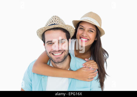 Happy casual man giving pretty girlfriend piggy back Stock Photo