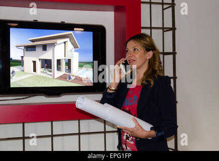 Architect talking on the phone with designs in hand Stock Photo