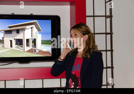 Architect talking on the phone and project on display Stock Photo