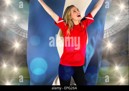Composite image of cheering football fan in red holding honduras flag Stock Photo