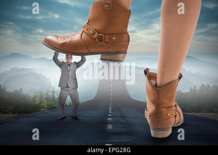 Composite image of cowboy boots stepping on businessman Stock Photo