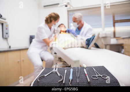 Pediatric dentist examining a little boys teeth with his assistant Stock Photo