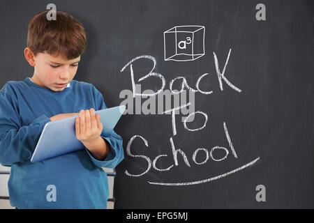 Composite image of cute boy using tablet Stock Photo