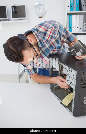 Computer engineer working on broken console Stock Photo