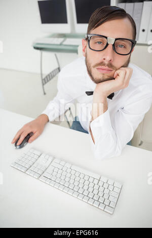 Nerdy bored businessman working on computer Stock Photo