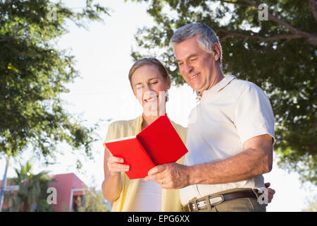 Happy senior couple using the guidebook Stock Photo
