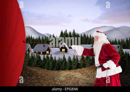 Composite image of santa pulls something with a rope Stock Photo