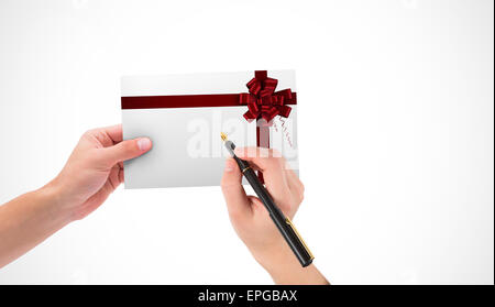 Composite image of hands holding card and pen Stock Photo