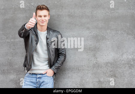 Casual young guy showing thumbs up Stock Photo