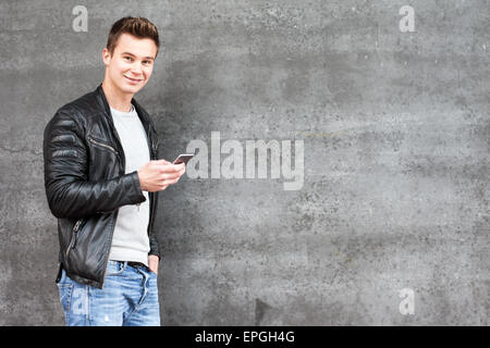 Attractive young guy using mobile Stock Photo