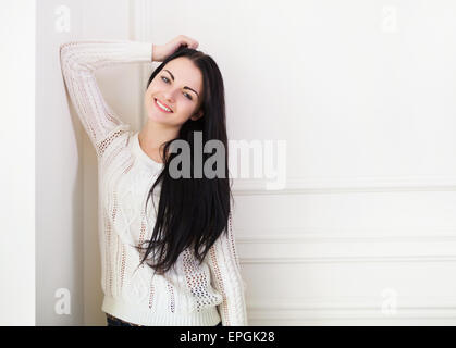 Happy cute teen girl near the wall in the room Stock Photo