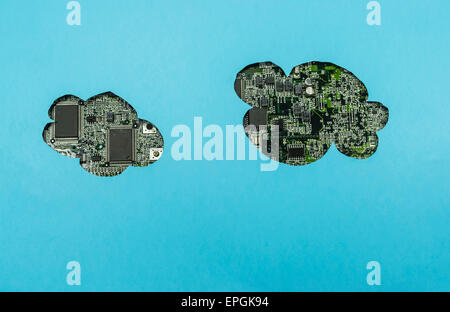 Cloud shape cuts on blue paper, with circuit board on background, concept for cloud computing Stock Photo
