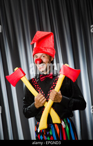 Funny clown with red axe Stock Photo