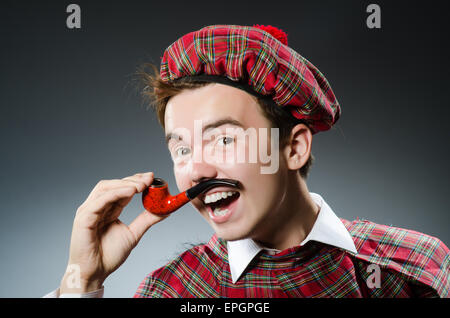 Funny scotsman smoking pipe tobacco Stock Photo