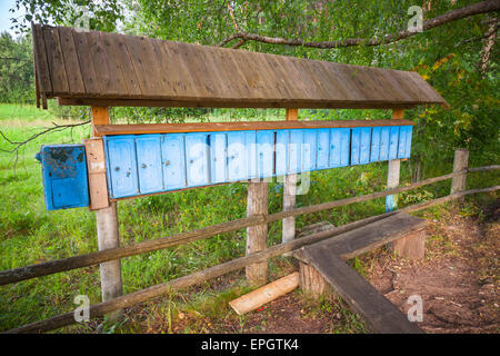 Old blue mailboxes in a row, small Russian village Stock Photo