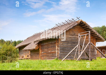 Russian rural wooden architecture example, old barns and swing Stock Photo