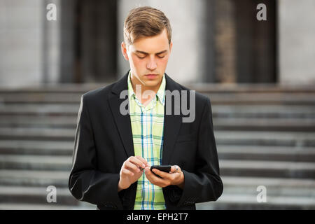 Young man calling on the mobile phone outdoor Stock Photo