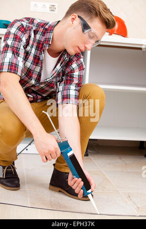 worker repairing the floor Stock Photo