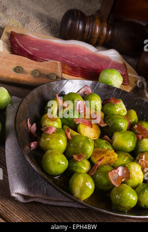 Honey caramelized brussels sprouts with ham Stock Photo