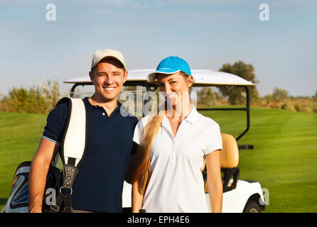 Young sportive couple playing golf on a golf course Stock Photo