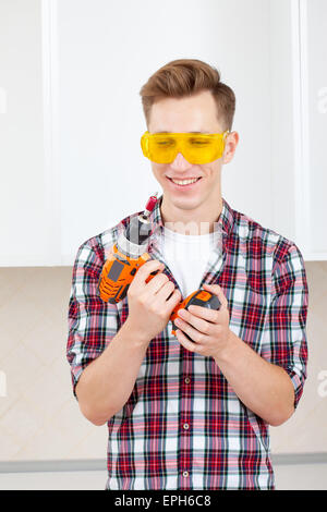 repairman with a drill near a computer Stock Photo