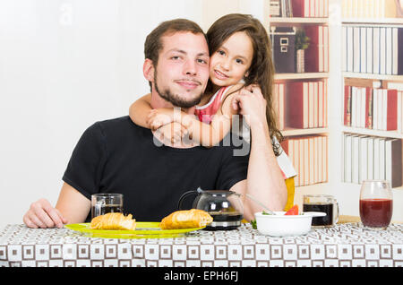 Fun loving dad having breakfast with small daughter Stock Photo - Alamy
