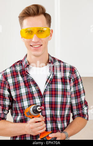 smiling repairman with a dril Stock Photo