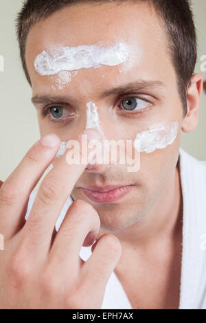 Man with cream in his face Stock Photo