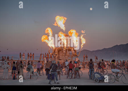 An art installation shoots flames in the desert during the annual Burning Man festival in the desert August 30, 2014 in Black Rock City, Nevada. Stock Photo