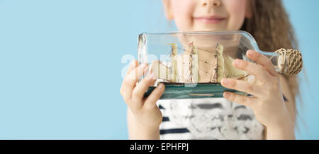 Toy ship in the fancy bottle Stock Photo